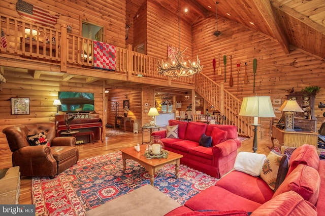 living room with wood ceiling, beam ceiling, an inviting chandelier, high vaulted ceiling, and hardwood / wood-style floors