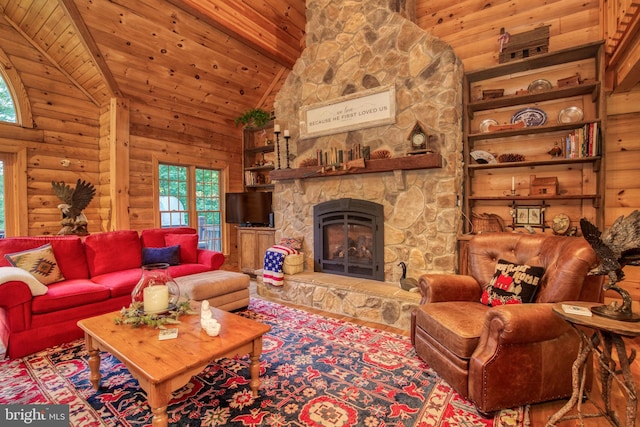 living room featuring beamed ceiling, a stone fireplace, wood ceiling, and high vaulted ceiling