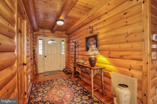 foyer featuring wood ceiling, beam ceiling, wood-type flooring, and log walls