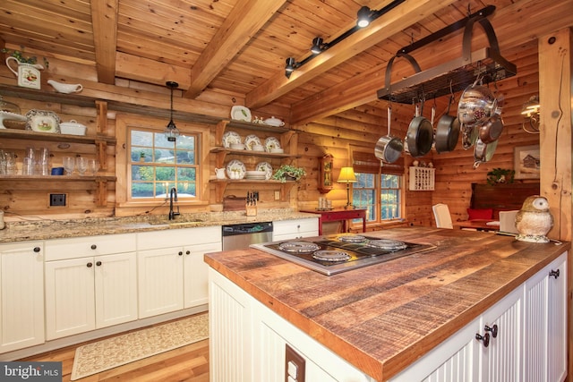 kitchen featuring white cabinets, sink, light wood-type flooring, appliances with stainless steel finishes, and decorative light fixtures