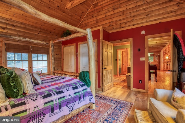 bedroom with light hardwood / wood-style flooring, beamed ceiling, wooden ceiling, and high vaulted ceiling