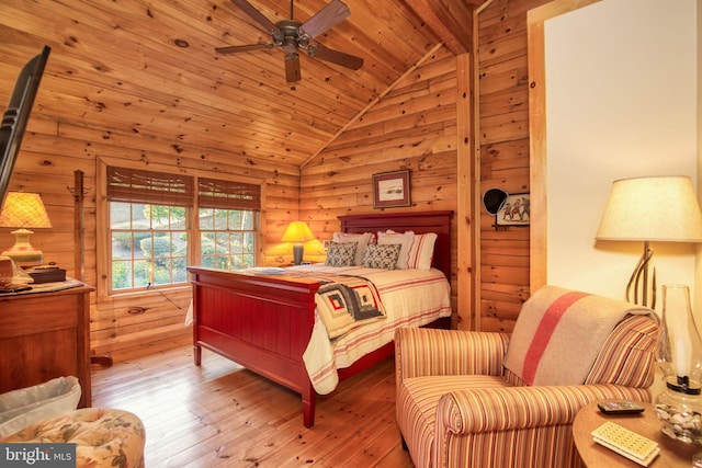 bedroom featuring hardwood / wood-style floors, wooden walls, vaulted ceiling with beams, ceiling fan, and wood ceiling