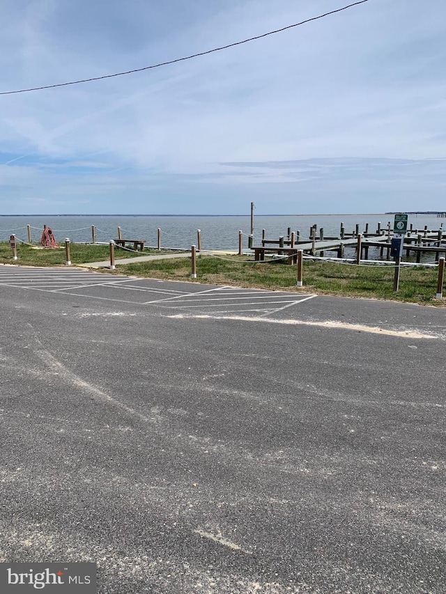 exterior space featuring a boat dock and a water view