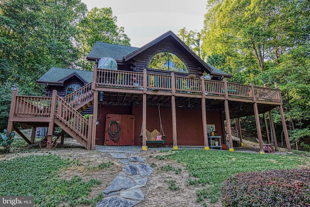 rear view of house featuring a wooden deck