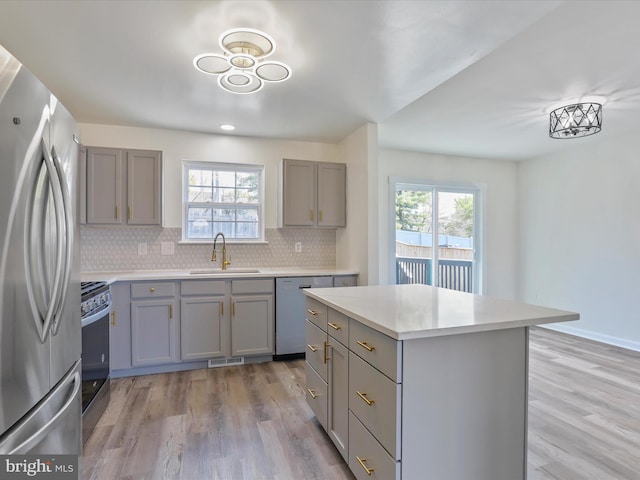 kitchen featuring light hardwood / wood-style flooring, stainless steel appliances, and a healthy amount of sunlight