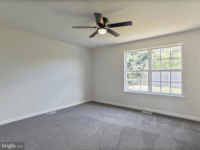 carpeted empty room featuring ceiling fan