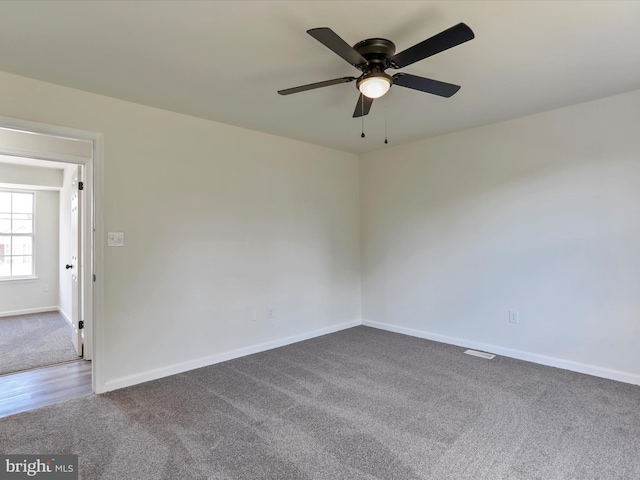 unfurnished room featuring carpet flooring, a ceiling fan, and baseboards