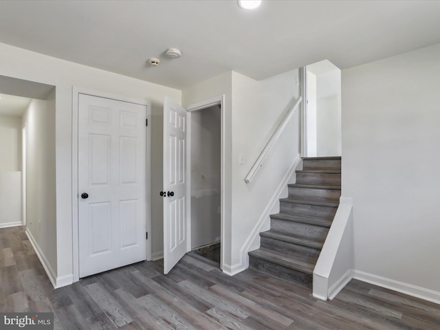 stairs featuring hardwood / wood-style flooring