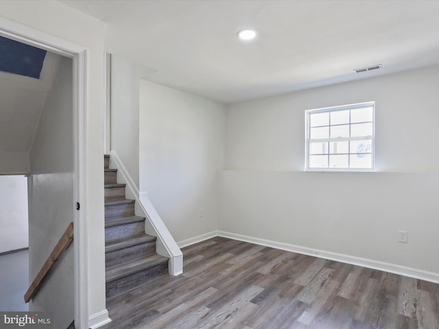 stairway with hardwood / wood-style flooring