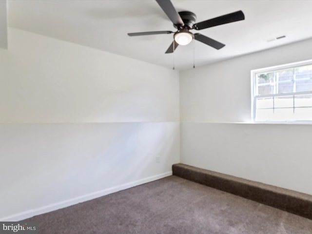 carpeted empty room featuring visible vents, baseboards, and a ceiling fan