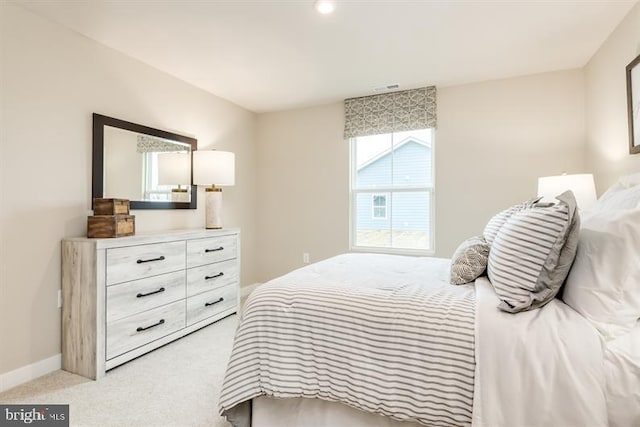 bedroom featuring light carpet