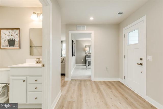 entryway with light wood-type flooring and sink