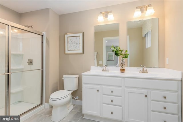 bathroom featuring vanity, toilet, a shower with shower door, and tile patterned flooring