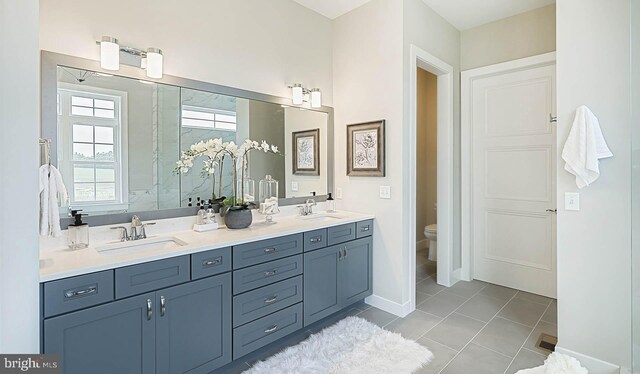 bathroom with vanity, toilet, and tile patterned floors