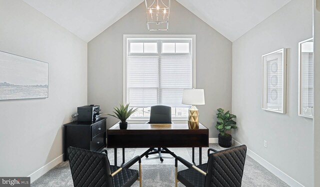 carpeted office with plenty of natural light, vaulted ceiling, and a notable chandelier