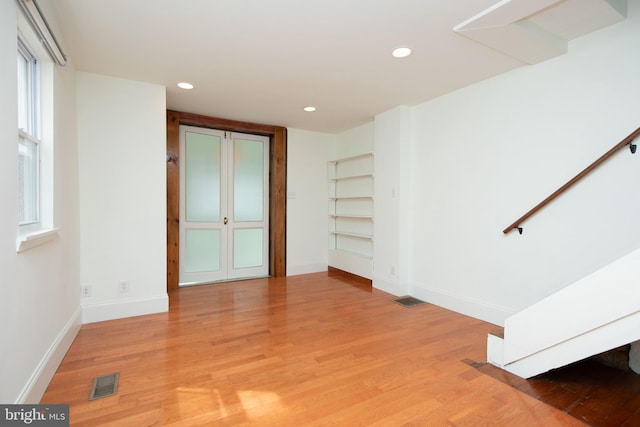 interior space with light hardwood / wood-style floors and plenty of natural light