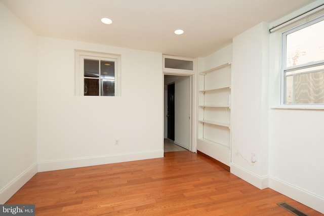 empty room with light hardwood / wood-style floors