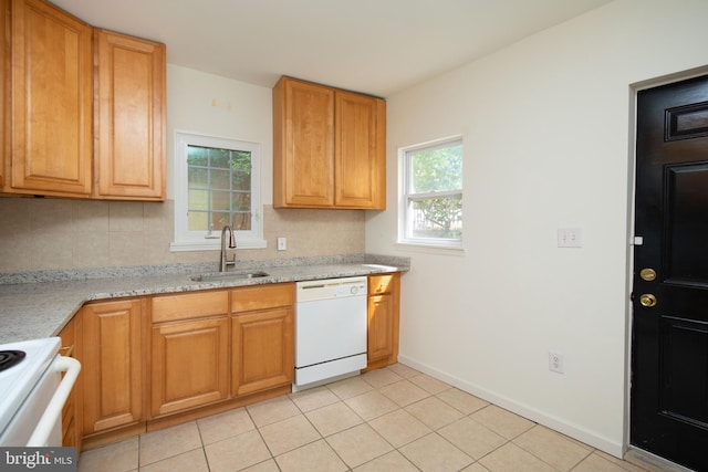 kitchen featuring light stone counters, light tile patterned flooring, sink, white appliances, and tasteful backsplash