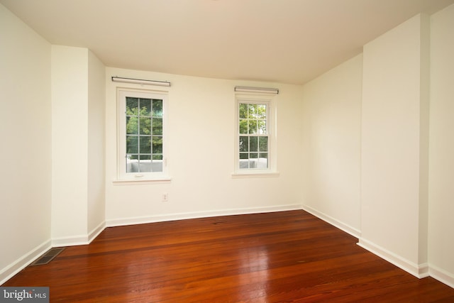 empty room featuring dark hardwood / wood-style flooring