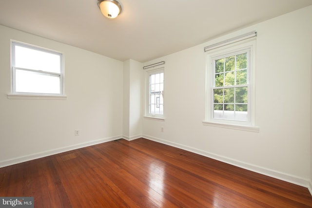 spare room with hardwood / wood-style floors