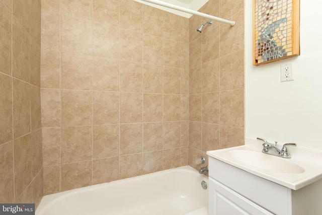 bathroom with vanity and tiled shower / bath