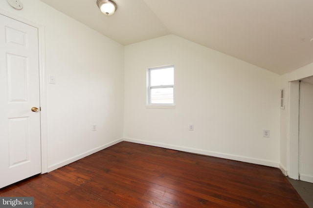 additional living space featuring lofted ceiling and dark wood-type flooring