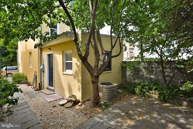 back of property featuring central air condition unit and a patio area