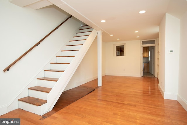 staircase with wood-type flooring