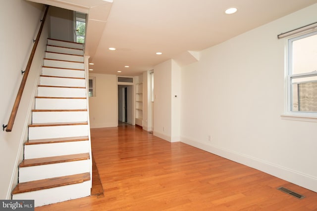 stairway with hardwood / wood-style flooring