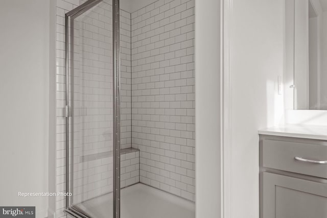 bathroom featuring vanity and an enclosed shower