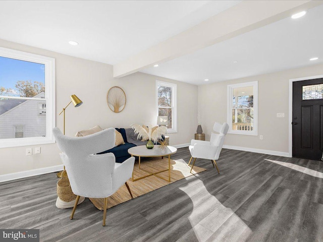 living room with beamed ceiling and dark hardwood / wood-style flooring