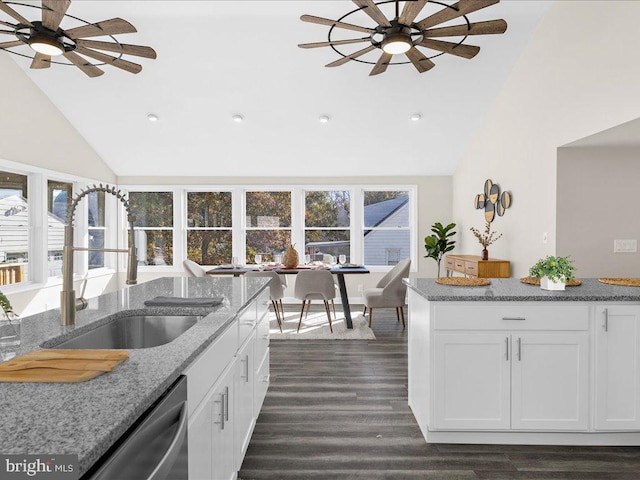 kitchen with white cabinets, light stone countertops, plenty of natural light, and sink