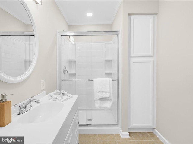 bathroom featuring tile patterned flooring, an enclosed shower, and vanity