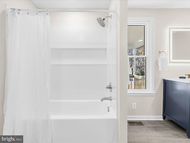 bathroom featuring shower / tub combo with curtain, vanity, and hardwood / wood-style flooring