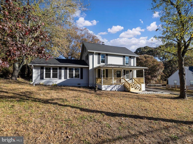 view of front facade featuring a front lawn and covered porch