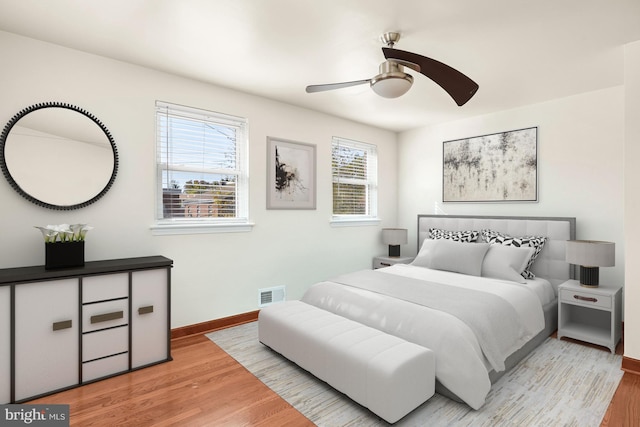 bedroom with light hardwood / wood-style floors and ceiling fan