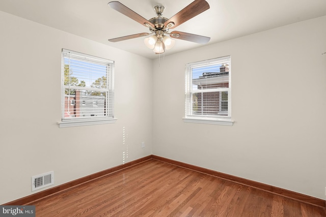 spare room featuring hardwood / wood-style floors and ceiling fan