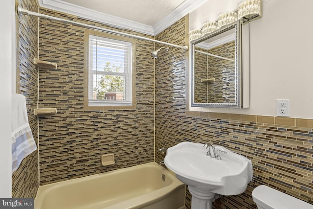 full bathroom with tile walls, sink, crown molding, tiled shower / bath, and toilet