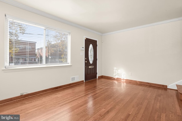 entryway featuring hardwood / wood-style floors and crown molding