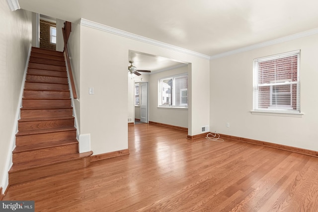 interior space featuring crown molding, light hardwood / wood-style floors, and ceiling fan