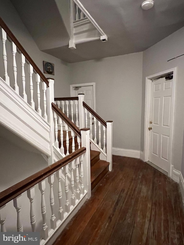 stairs featuring hardwood / wood-style floors