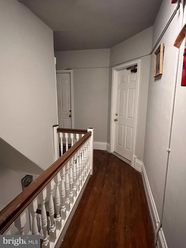 corridor with dark hardwood / wood-style floors