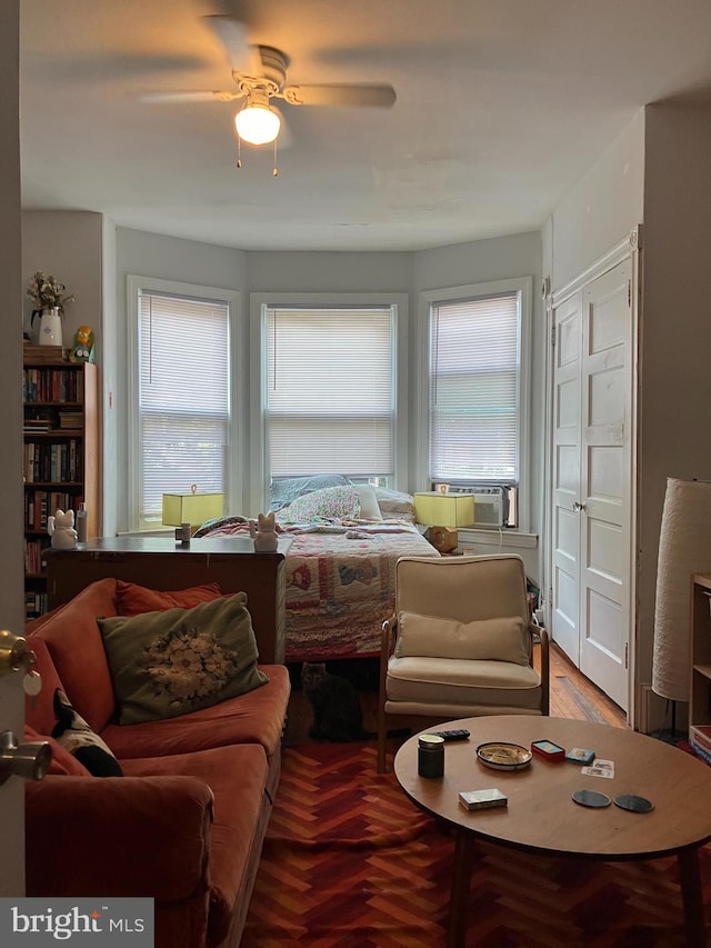 living room with wood-type flooring, cooling unit, and ceiling fan