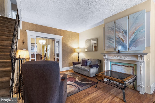 living room featuring hardwood / wood-style flooring and a textured ceiling