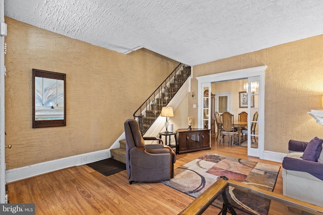 living room with hardwood / wood-style flooring and a textured ceiling