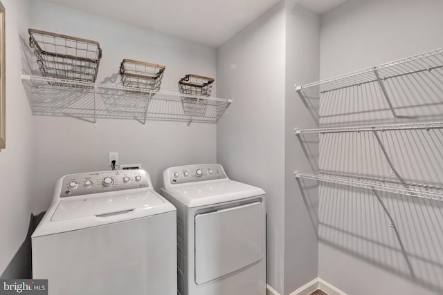 clothes washing area featuring separate washer and dryer