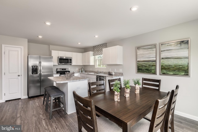 dining room with dark wood-type flooring and sink