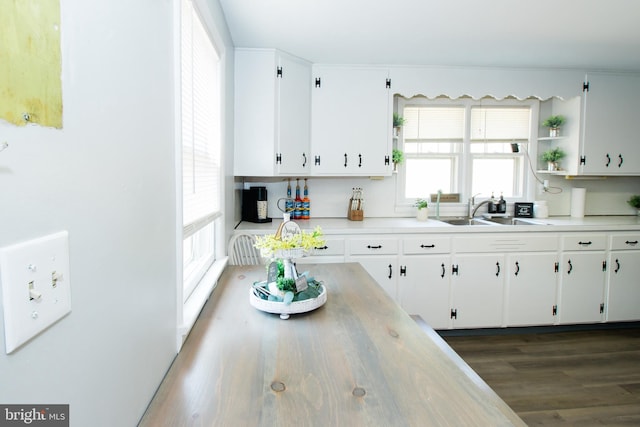 kitchen featuring white cabinetry, sink, and dark hardwood / wood-style floors