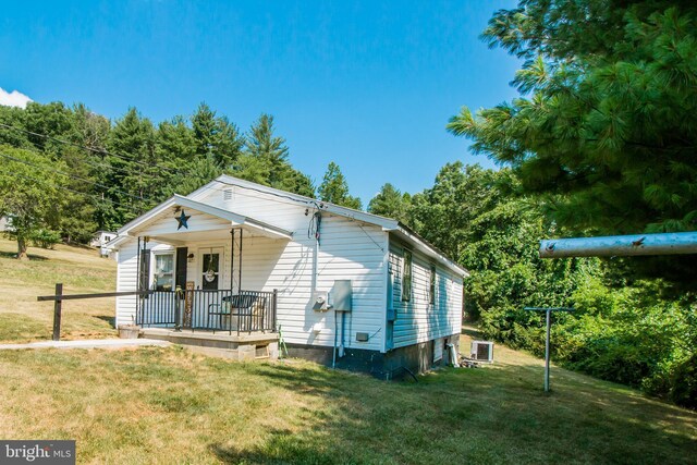 exterior space with a front lawn and central air condition unit