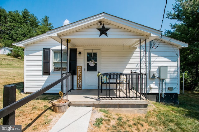 view of front of home with a front yard and covered porch